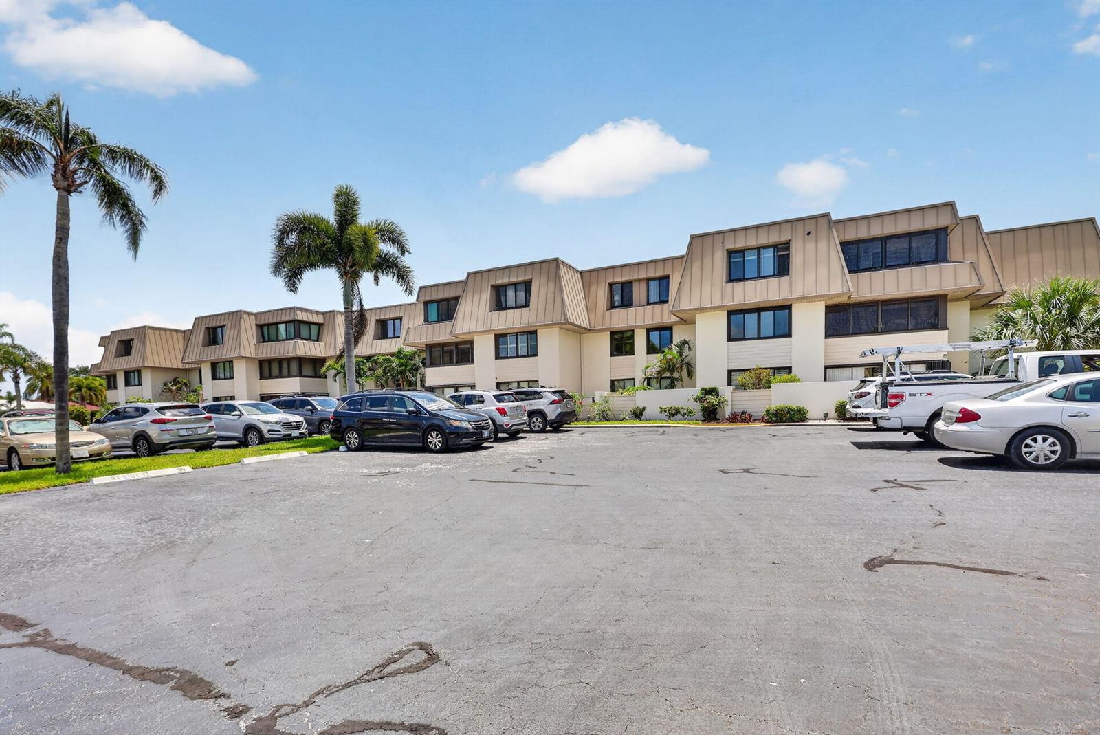A multi-story apartment building with a parking lot in the foreground — 1800 SE Saint Lucie Boulevard # 203, Stuart FL 34996, STUART, FL