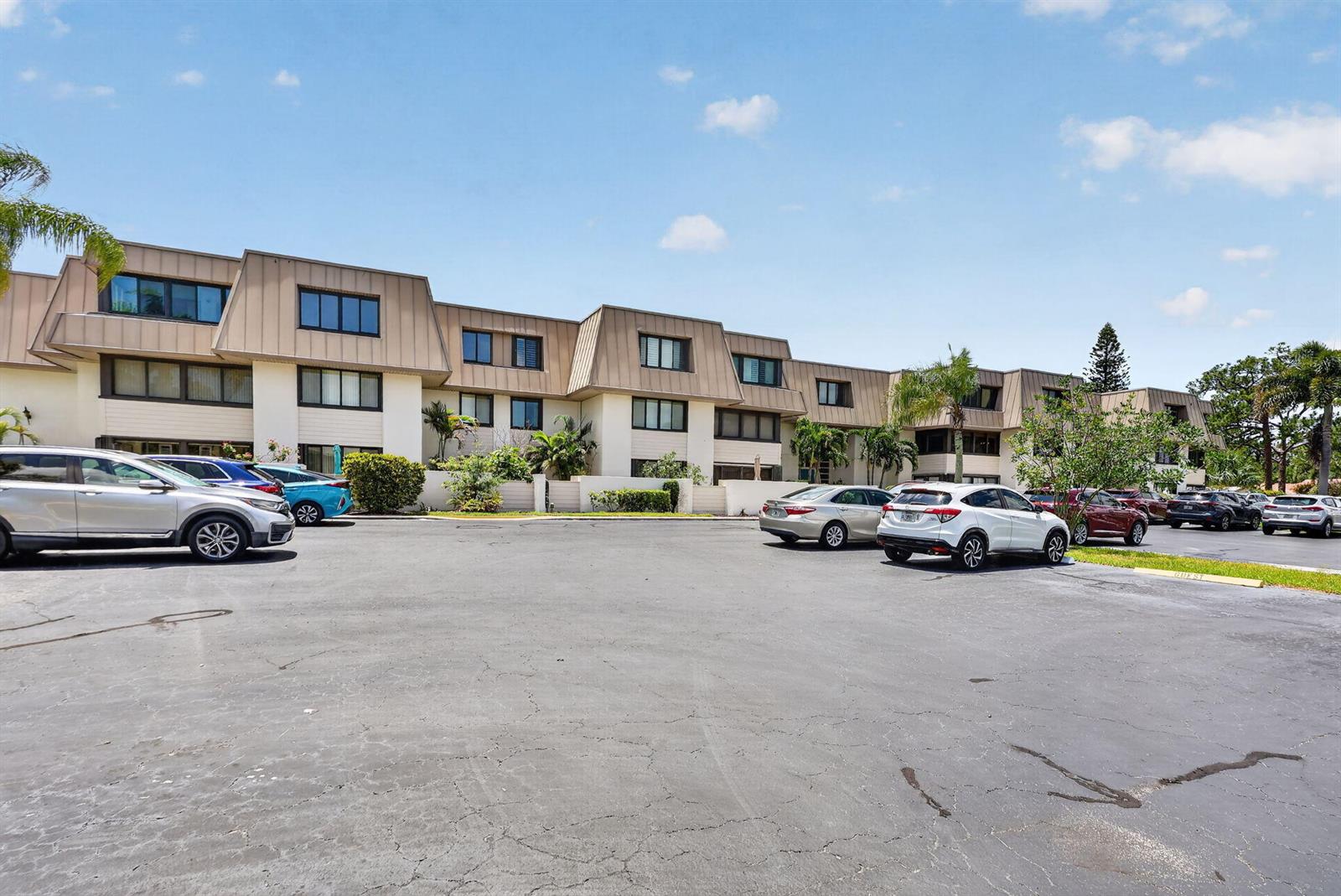 A multi-story apartment building with a parking lot in the foreground — 1800 SE Saint Lucie Boulevard # 203, Stuart FL 34996, STUART, FL