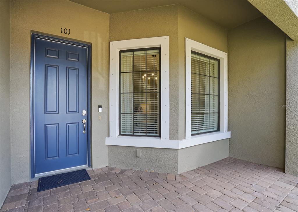 A blue front door with the number 101 sits next to two windows on a patio — 12720 SORRENTO WAY UNIT 101, BRADENTON, FL