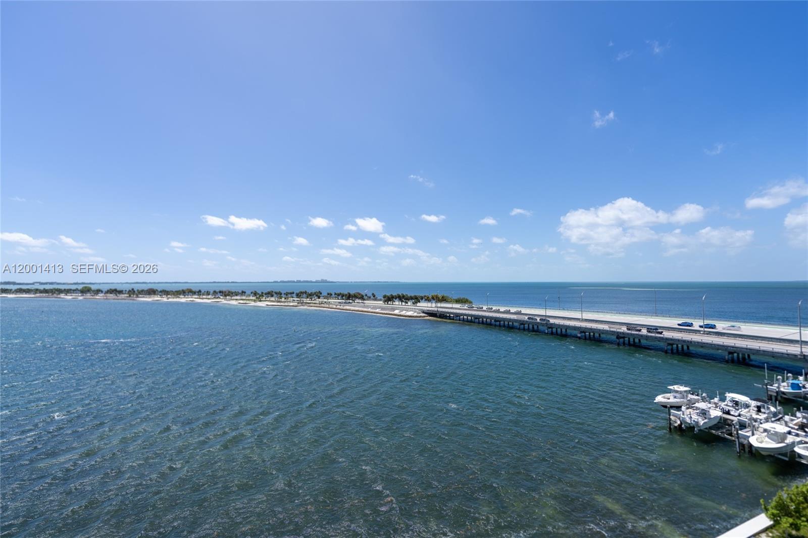 An elevated view shows a bridge extending over the ocean with boats docked nearby — 175 SE 25 Rd # 501, Miami FL 33129, MIAMI, FL