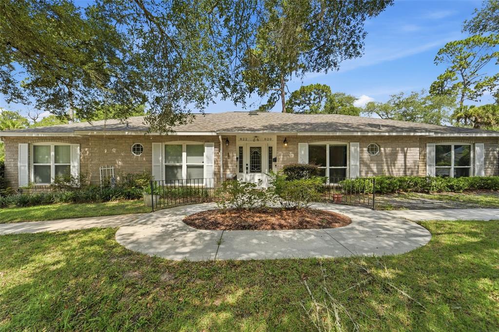 A single-story brick duplex with a central entrance and a circular concrete walkway — 820 S HILL AVENUE UNIT 40, DELAND, FL