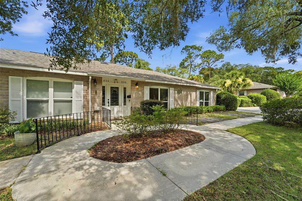 A single-story brick duplex with a curved concrete walkway and a central shared entryway — 820 S HILL AVENUE UNIT 40, DELAND, FL