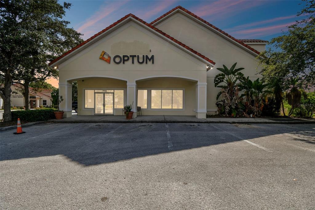 A single-story commercial building with an Optum sign and a paved parking lot in front — 772 CORTARO DRIVE, SUN CITY CENTER, FL