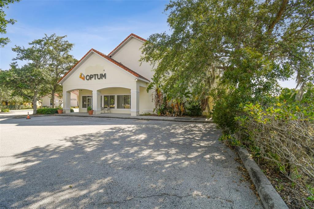 A single-story commercial building with an Optum sign sits behind a paved parking lot — 772 CORTARO DRIVE, SUN CITY CENTER, FL