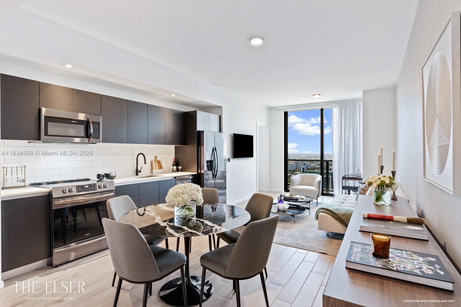 This modern apartment features an open-concept kitchen, dining area, and living space with floor-to-ceiling windows — 398 NE 5th St # 4018, Miami FL 33132, MIAMI, FL