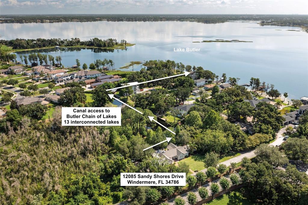 An aerial view shows a house with a canal leading to a large lake — 12085 SANDY SHORES DRIVE UNIT D, WINDERMERE, FL