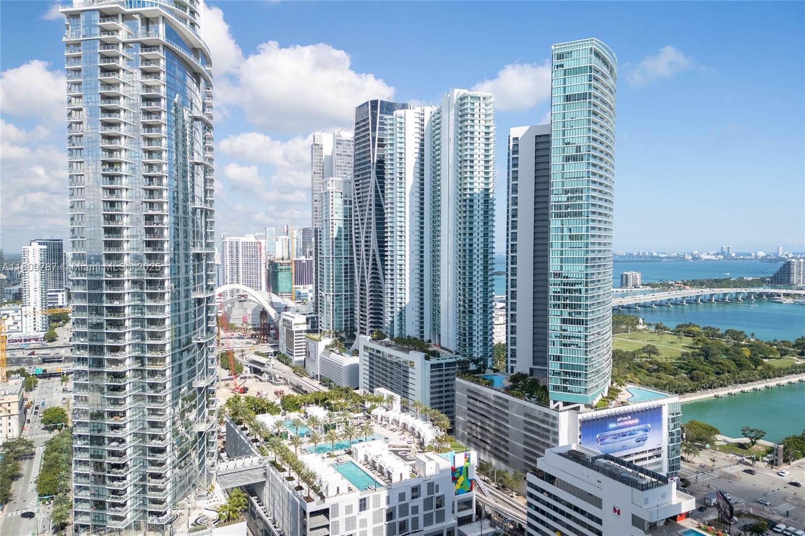 An aerial view of a dense Miami skyline featuring modern glass skyscrapers and waterfront parks — 159 NE 6th St # 2901, Miami FL 33132, MIAMI, FL