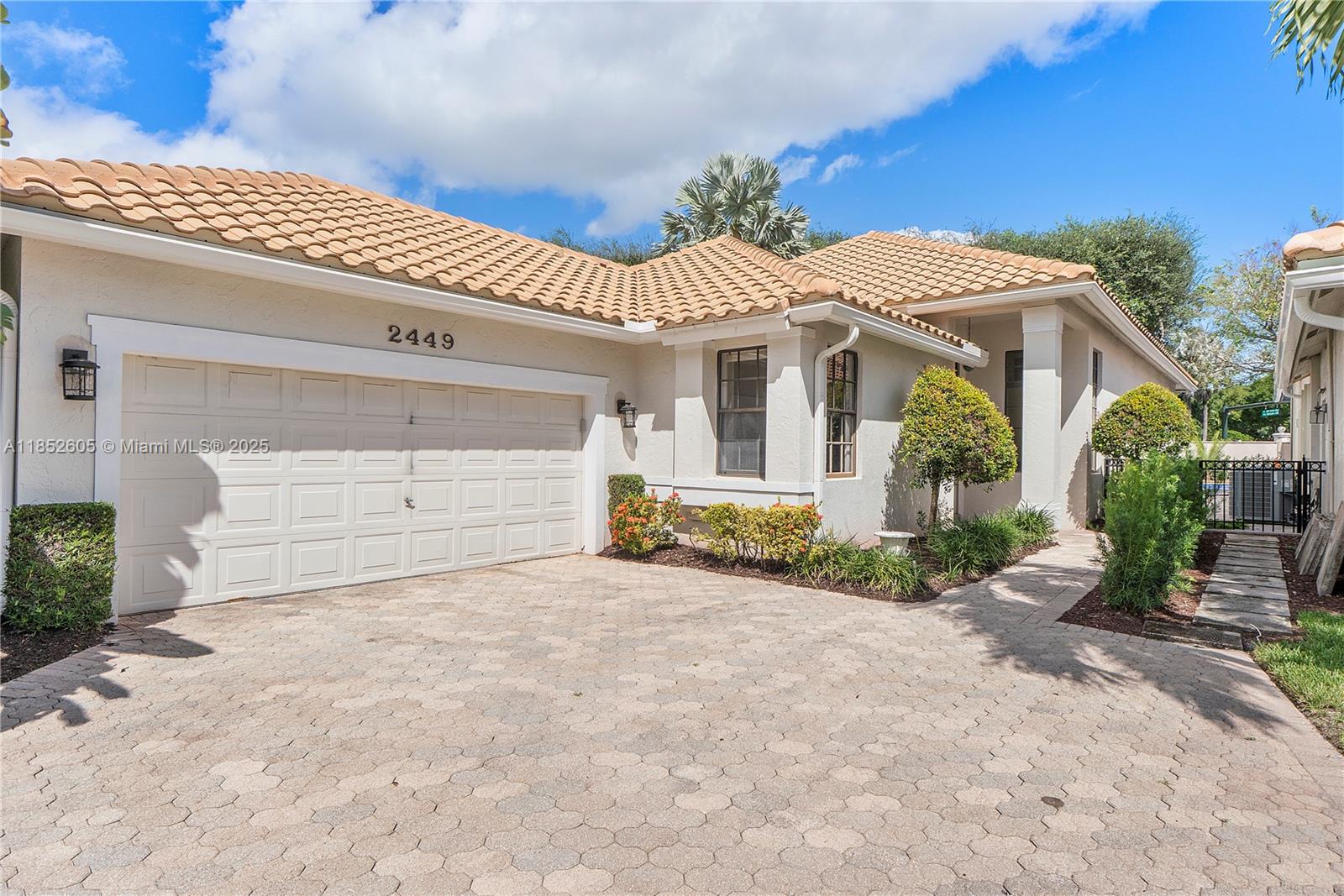 A single-story house features a tiled roof, a two-car garage, and a paved driveway — 2449 NW 64th St, Boca Raton FL 33496, BOCA RATON, FL