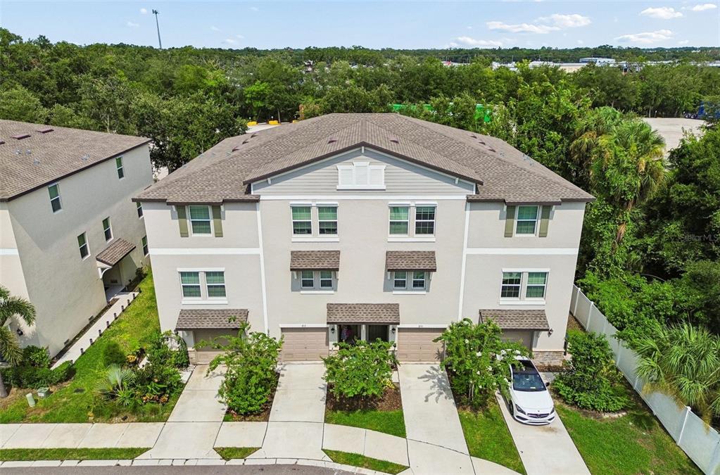 The exterior view shows a garage door, a front door, and a potted plant — 852 TENNYSON MILL CIRCLE, TAMPA, FL