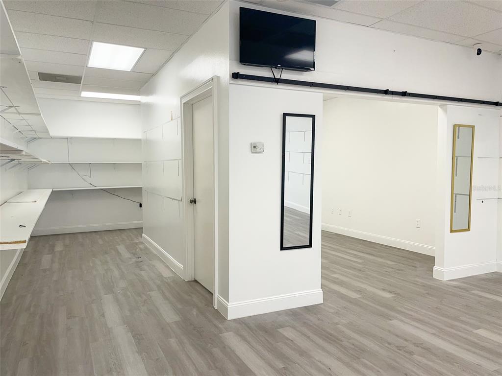 An interior view of a room with white walls, gray flooring, and built-in shelving — 5508 US HIGHWAY 98 N, LAKELAND, FL