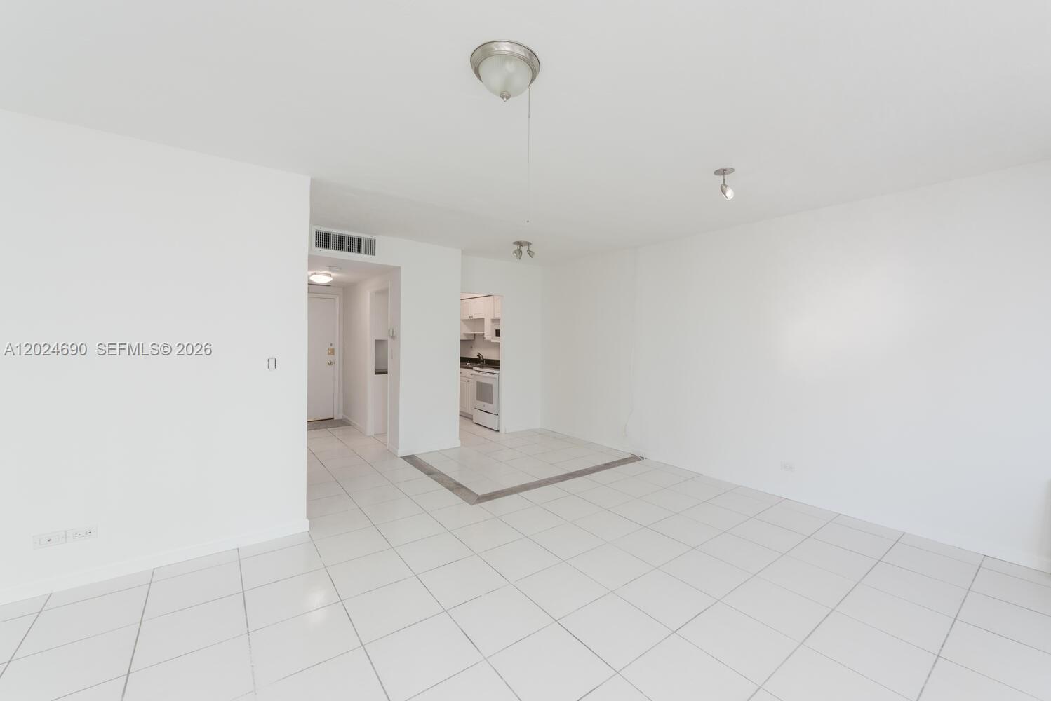 A multi-story white residential building stands behind a gated entrance with palm trees — 1408 Brickell Bay Dr # 1116, Miami FL 33131, MIAMI, FL