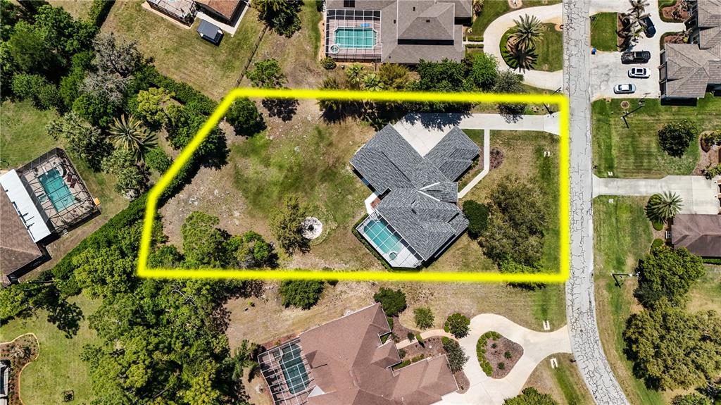 An aerial view shows a house with a pool and a large yard — 5250 MACOSO COURT, NEW PORT RICHEY, FL