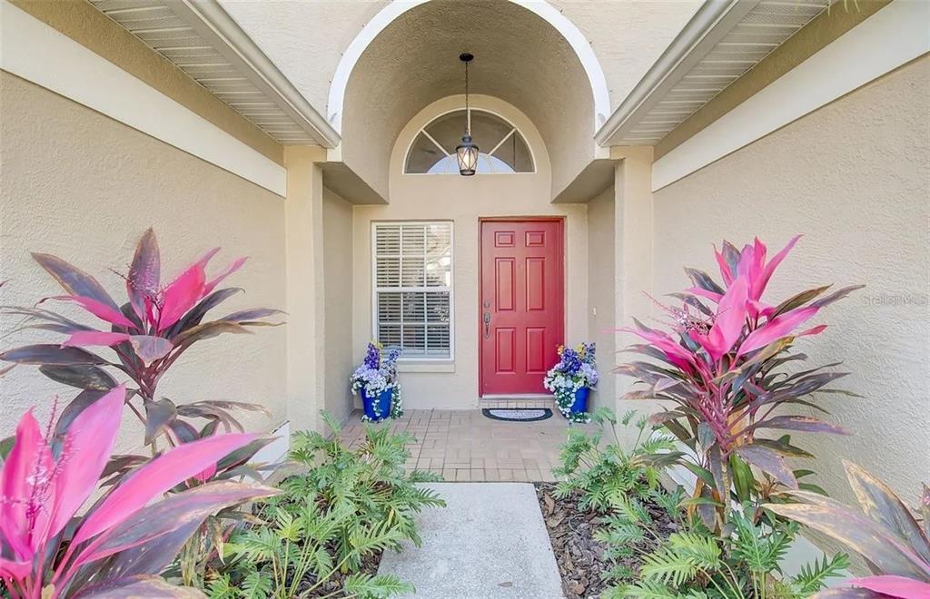 A bathroom features a double vanity with white countertops, a soaking tub, and marble-look flooring — 3137 CASTLE ROCK CIRCLE, LAND O LAKES, FL