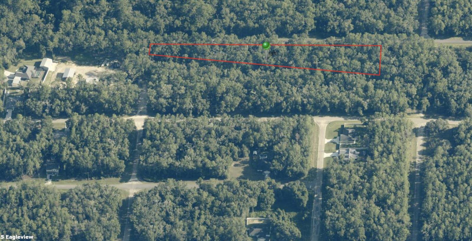 An aerial view shows a wooded, trapezoidal plot of land outlined in red — 182 E Kingsdale Street, FL 34434, FL