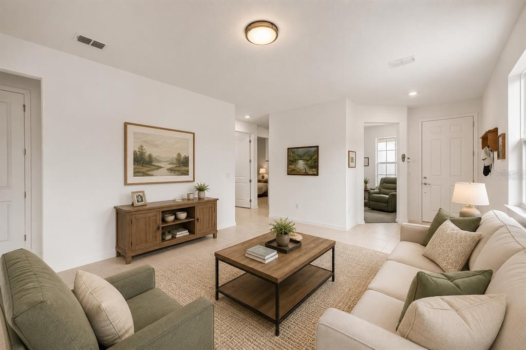 A living room features a beige sofa, green armchair, wooden coffee table, and console table — 9412 SW 53RD PLACE, OCALA, FL
