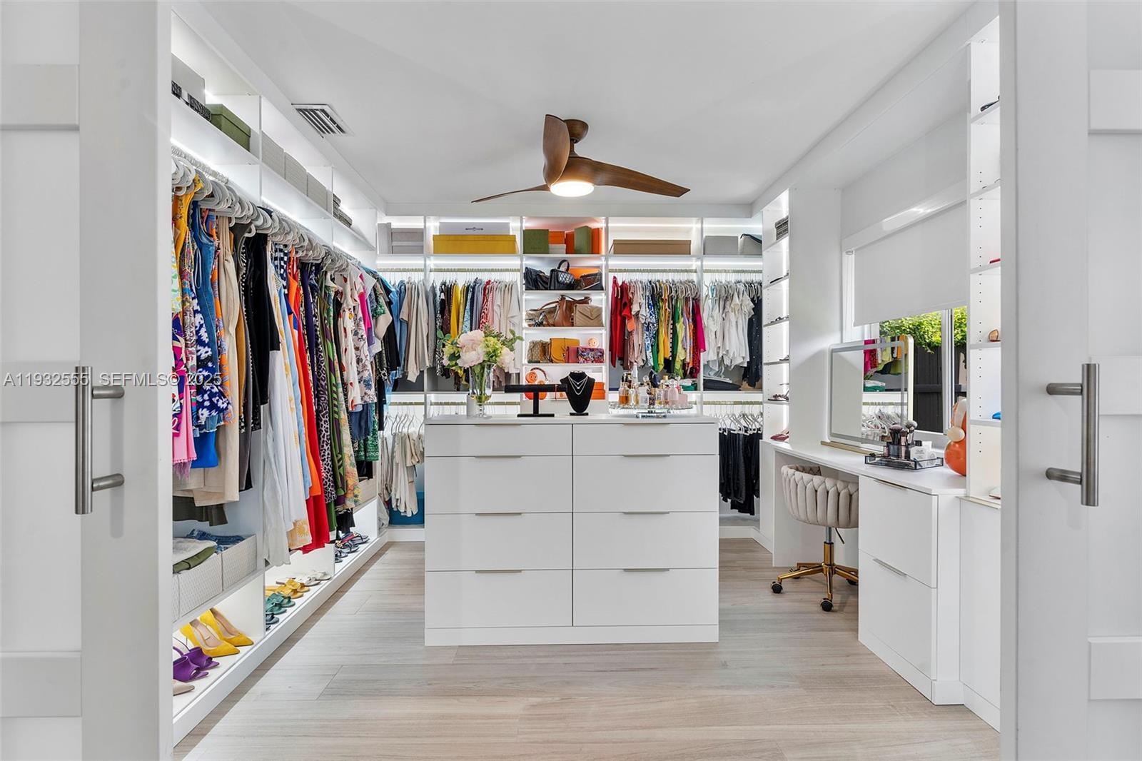 A walk-in closet features white cabinetry, a central island, a vanity, and a ceiling fan — 550 NW 110th Ave, Plantation FL 33324, PLANTATION, FL