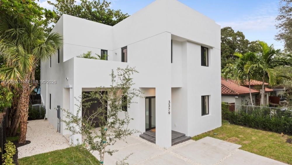 A modern two-story white house with a flat roof, dark window frames, and a driveway — 3379 William Ave, Miami FL 33133, MIAMI, FL