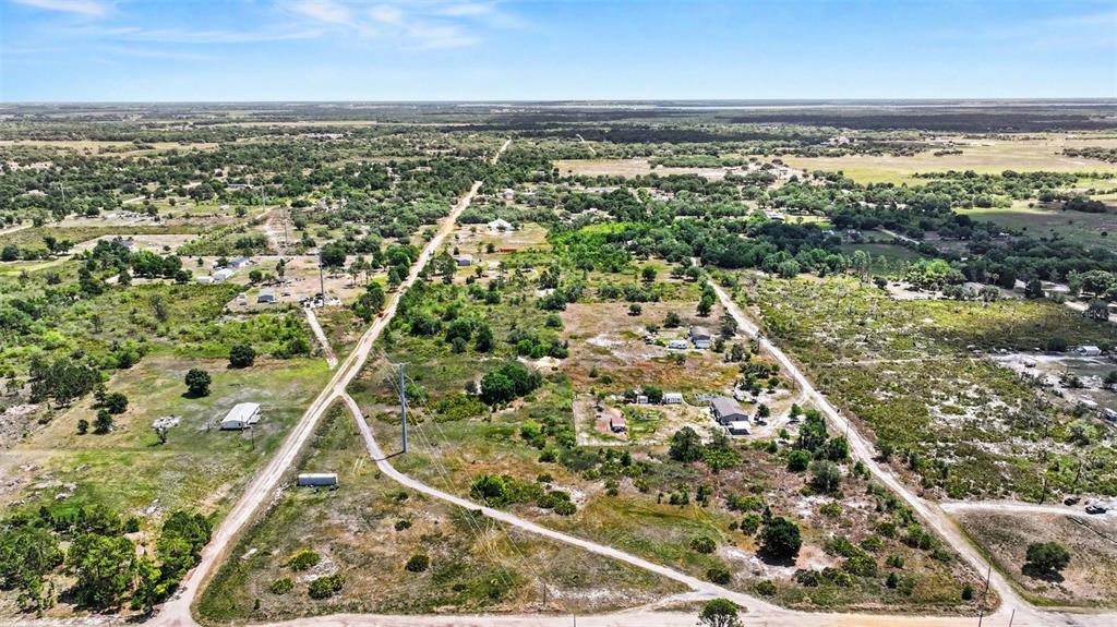 An aerial view shows a rural landscape with dirt roads, scattered trees, and several small buildings — 0 ALLISON AVENUE, LAKE WALES, FL