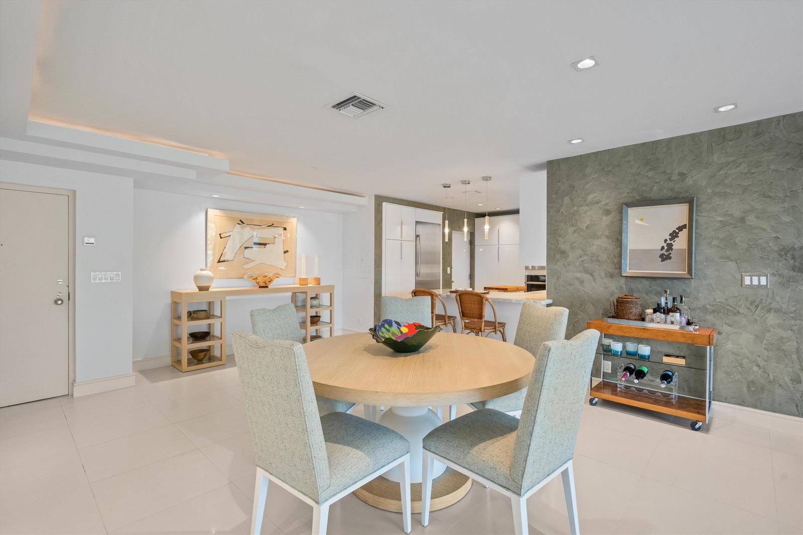 A dining area features a round wooden table, four upholstered chairs, and a bar cart — 2275 S Ocean Boulevard, Palm Beach FL 33480, PALM BEACH, FL