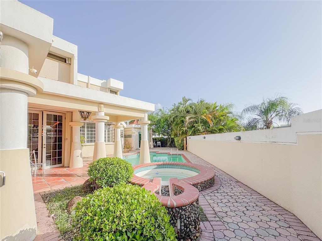 A patio area features a small pool, a hot tub, and a covered porch — 21 PQUE. TIVOLI | PASEO DEL PARQUE, SAN JUAN, PR