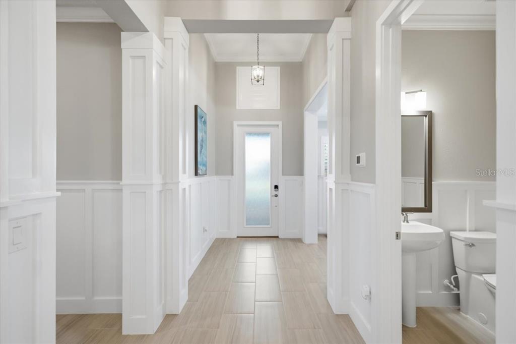 A bright, modern kitchen features white cabinetry, a large central island, and stainless steel appliances — 2110 E 6TH STREET W, PALMETTO, FL
