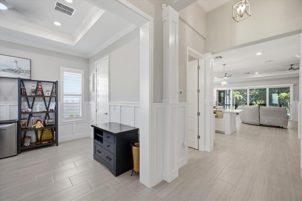 A single-story house with a white stucco exterior, a tile roof, and a paved driveway — 2110 E 6TH STREET W, PALMETTO, FL