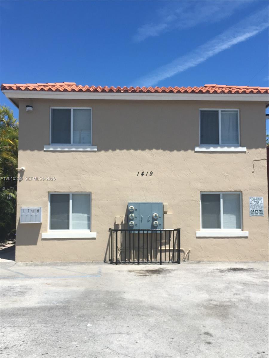 A two-story stucco apartment building features a red tile roof and four windows — 1419 SW 22nd Ave # 4, Miami FL 33145, MIAMI, FL