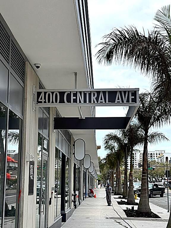 A sidewalk runs along the exterior of a building with a 400 Central Ave sign — 400 CENTRAL AVENUE UNIT 2603, ST PETERSBURG, FL