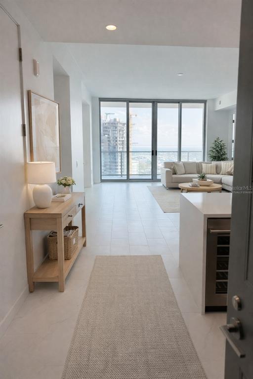 A bright entryway leads into a living room with floor-to-ceiling windows and city views — 400 CENTRAL AVENUE UNIT 2603, ST PETERSBURG, FL