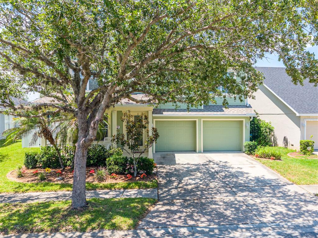 A two-story house with a two-car garage and a large tree in the front yard — 4930 ATWOOD DRIVE, ORLANDO, FL
