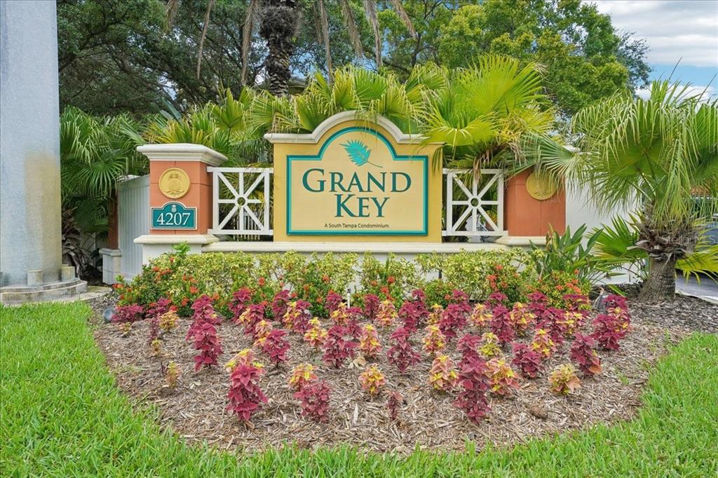 An exterior view of a three-story apartment building with a parking lot in front — 4207 S DALE MABRY HIGHWAY UNIT 5307, TAMPA, FL