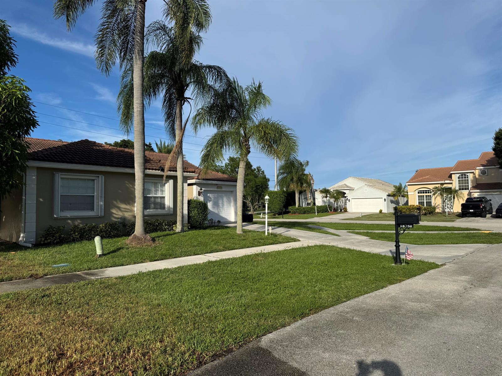 A suburban street view features single-story houses with palm trees and manicured lawns — 18750 Caspian Circle, Boca Raton FL 33496, BOCA RATON, FL