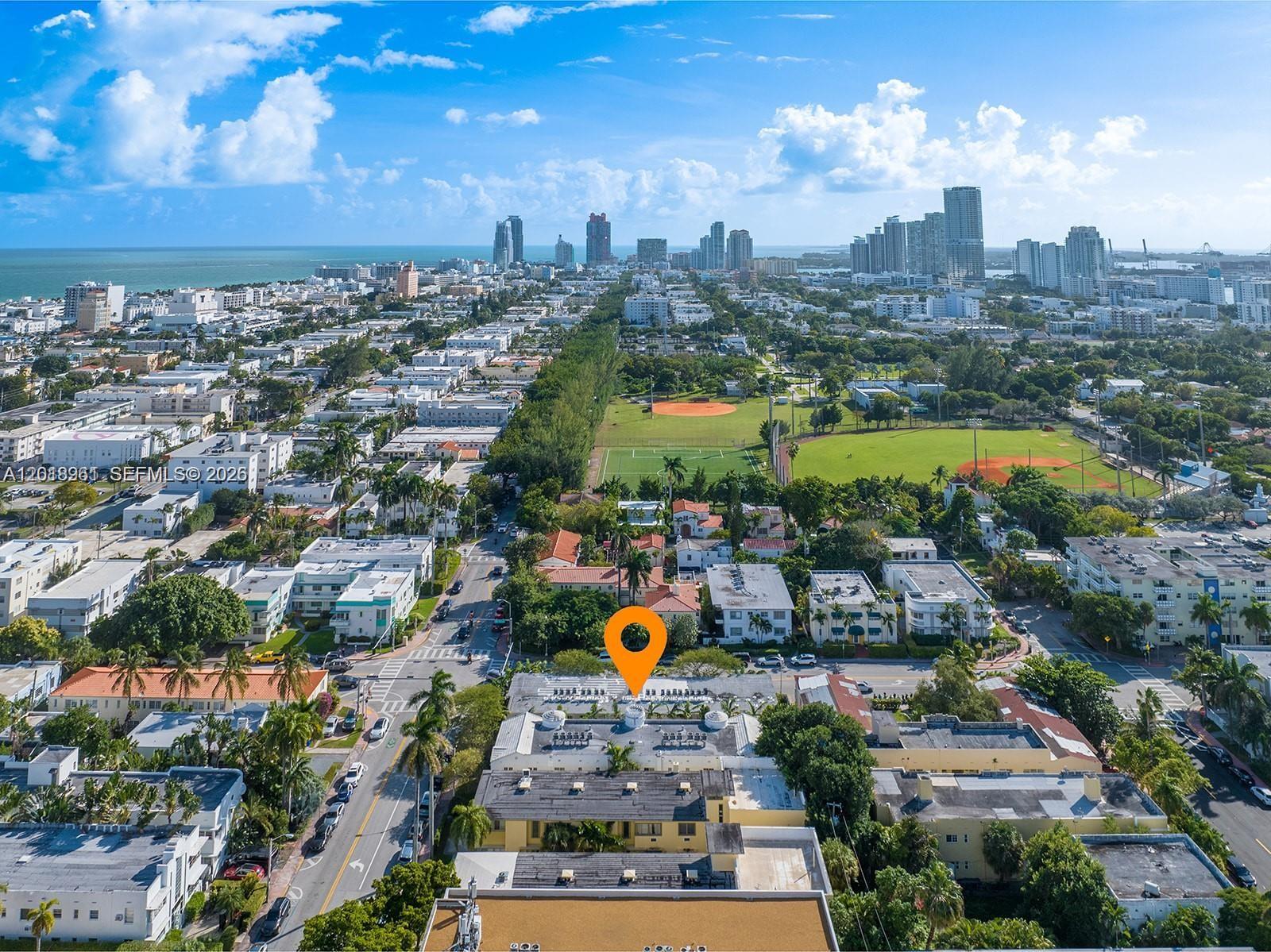 An aerial view shows a low-rise apartment building marked with a pin in a city — 1508 Meridian Ave, Miami Beach FL 33139, MIAMI BEACH, FL