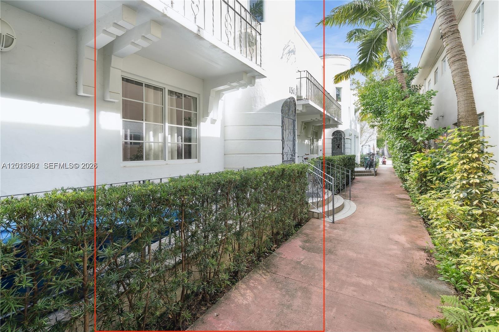 A white multi-story building features balconies, arched entryways, and a sidewalk lined with hedges — 1508 Meridian Ave, Miami Beach FL 33139, MIAMI BEACH, FL