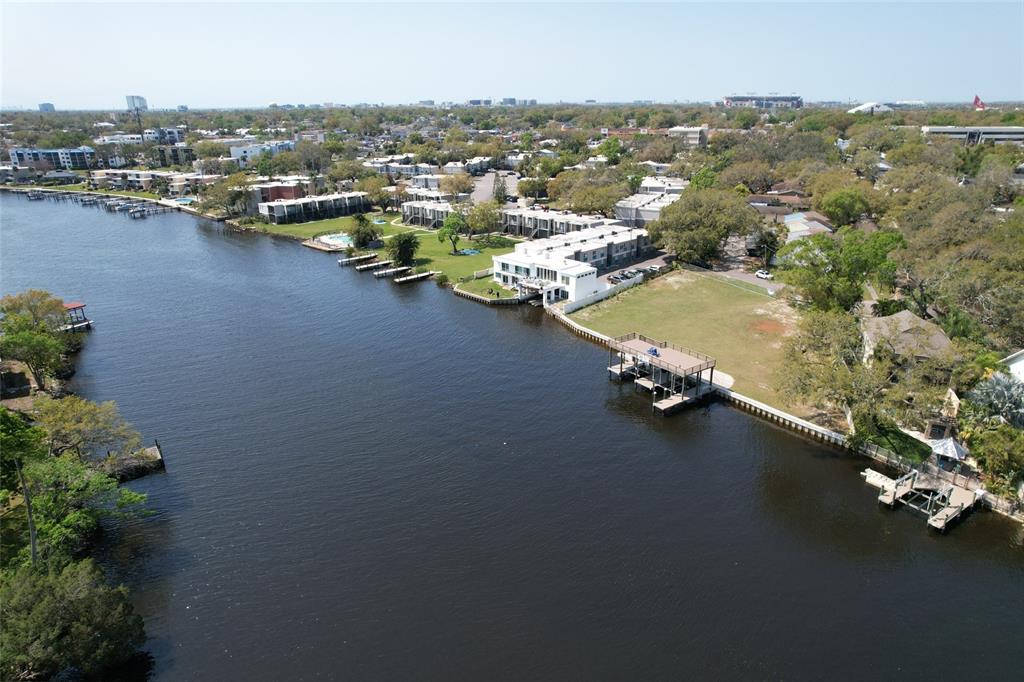 An aerial view shows a waterfront residential complex with docks along a river — 4033 N RIVER VIEW AVENUE, TAMPA, FL