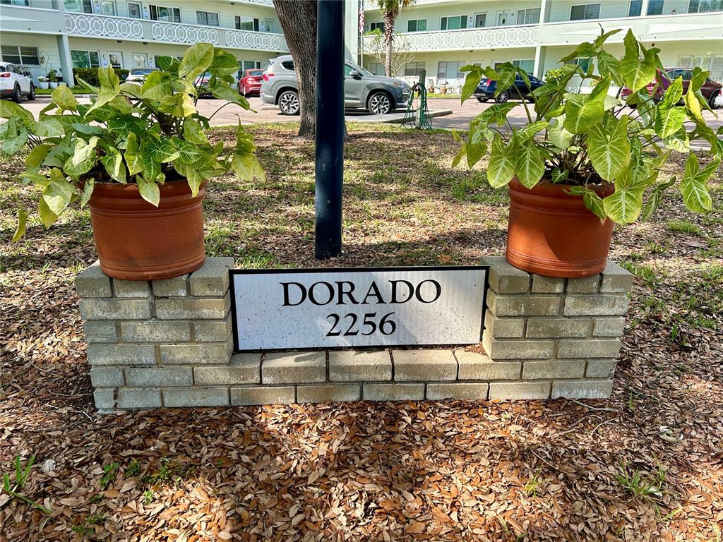A brick sign displaying the name Dorado and the number 2256 sits between two potted plants — 2256 PHILIPPINE DRIVE UNIT 42, CLEARWATER, FL