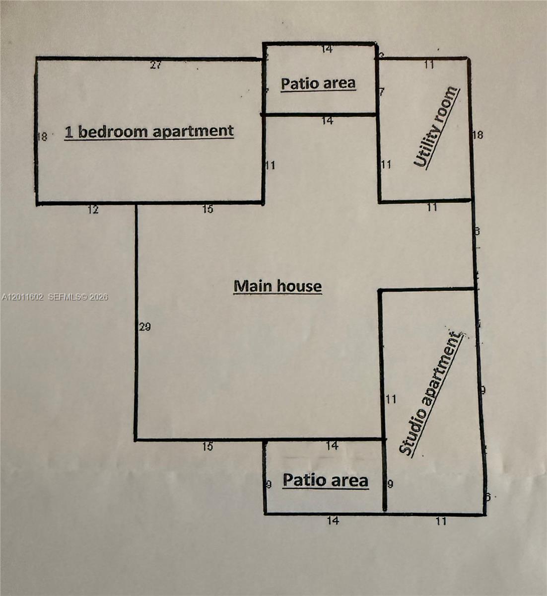 A tiled living room features a fireplace with a large mirror above it and an adjacent kitchen — 40 SE 8th St, Dania Beach FL 33004, DANIA BEACH, FL