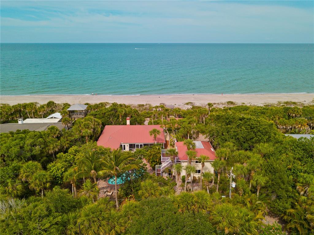 An aerial view of a beachfront house with a red roof and a swimming pool — 8300 MANASOTA KEY ROAD, ENGLEWOOD, FL