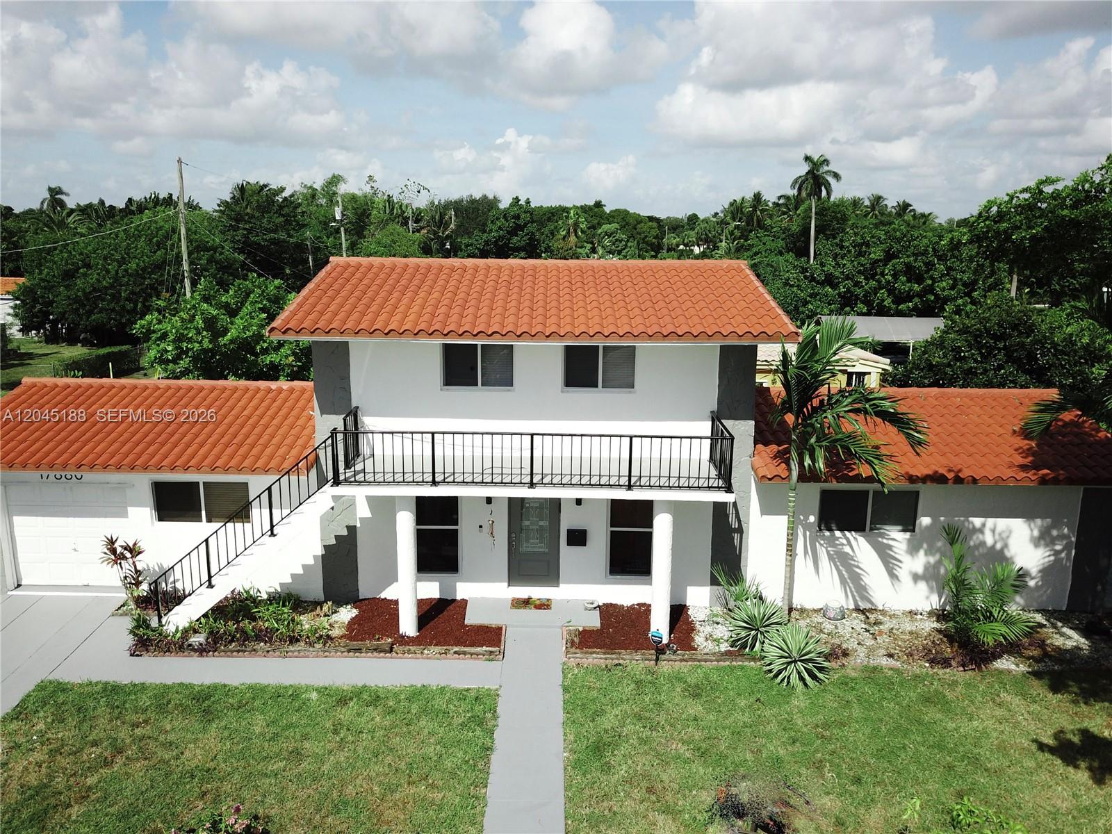 An aerial view of a two-story house with a red tile roof and exterior staircase — 17880 NE 13th Ave, North Miami Beach FL 33162, NORTH MIAMI BEACH, FL