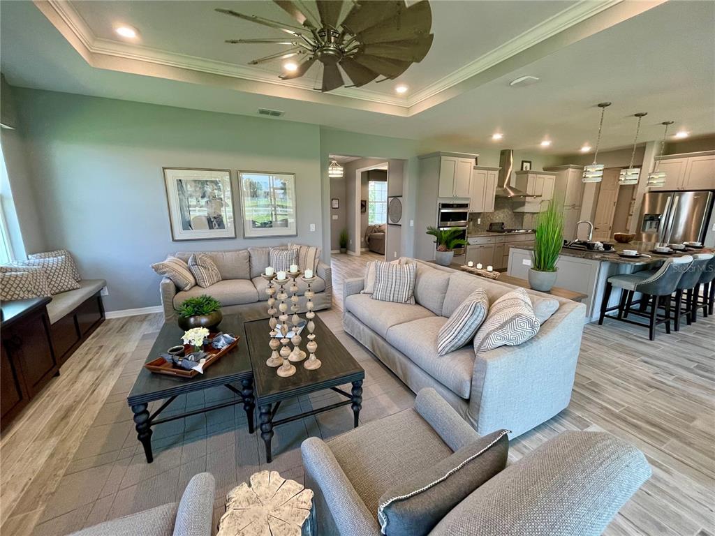 A living room with two sofas, a coffee table, and an open kitchen area — 9152 SW 85TH PLACE, OCALA, FL