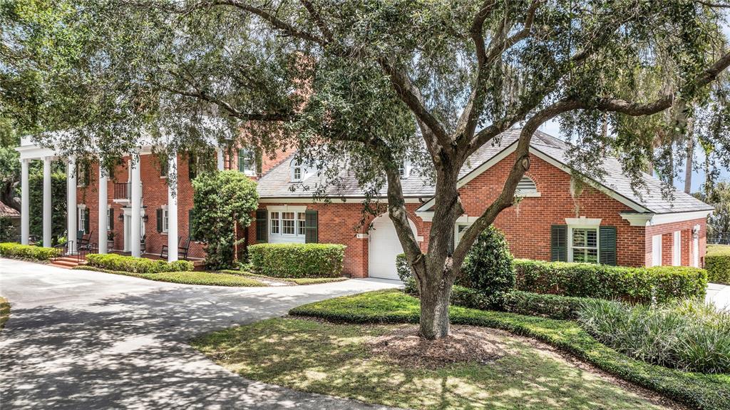 A two-story brick house with a white-columned porch and an attached garage — 1530 WATERWITCH DRIVE, ORLANDO, FL