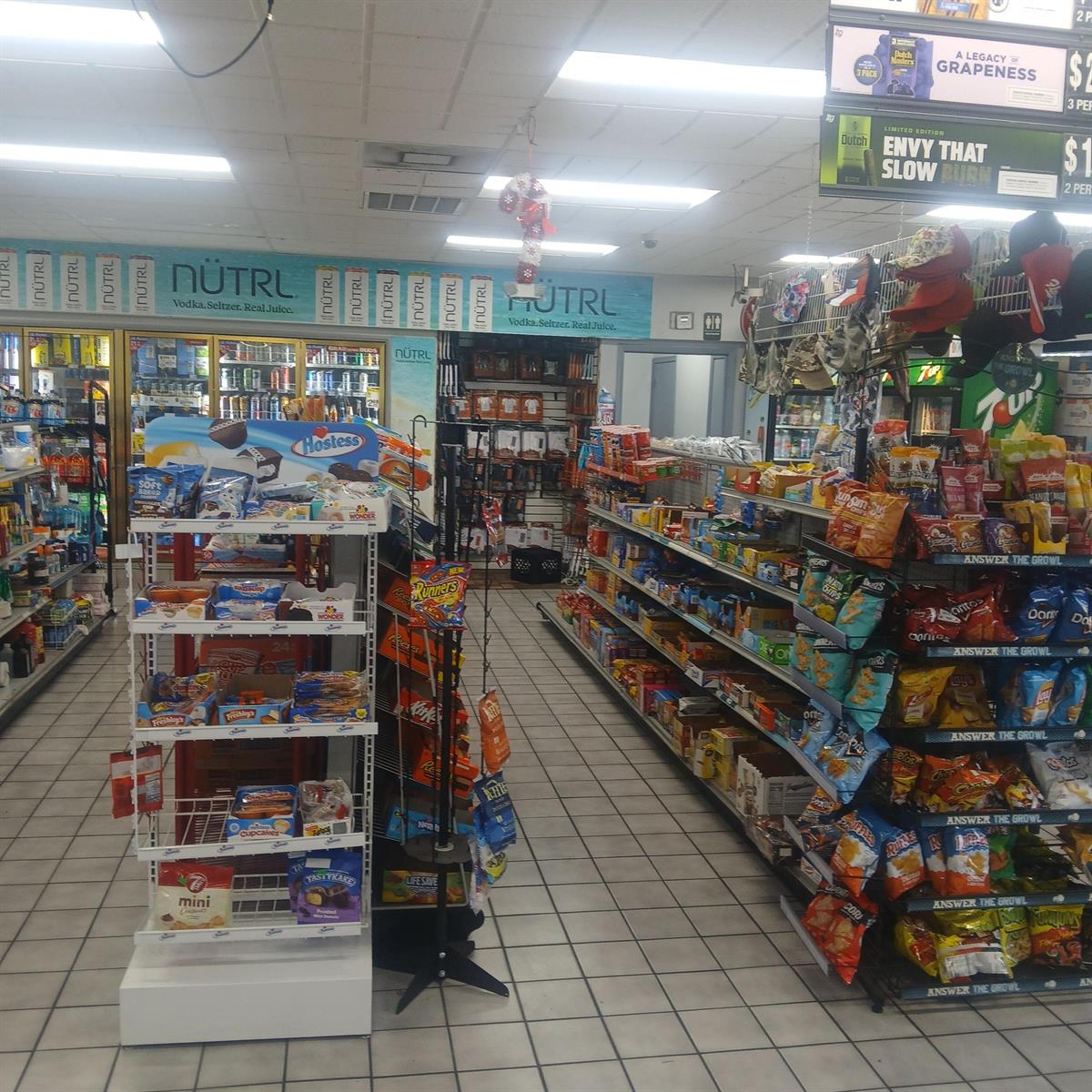 A convenience store interior features aisles stocked with snacks, drinks, and various retail merchandise — 2501 Orange Avenue, Fort Pierce FL 34947, FORT PIERCE, FL
