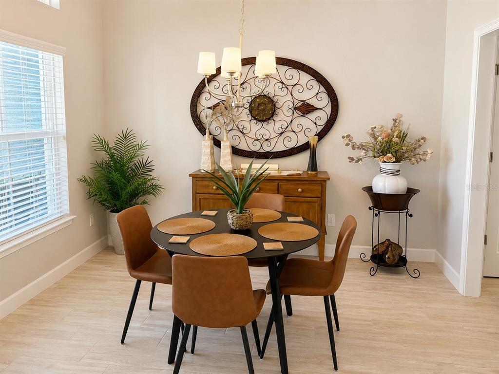 A dining room features a round table, four brown chairs, and a wooden sideboard — 4869 SW 115TH STREET, OCALA, FL