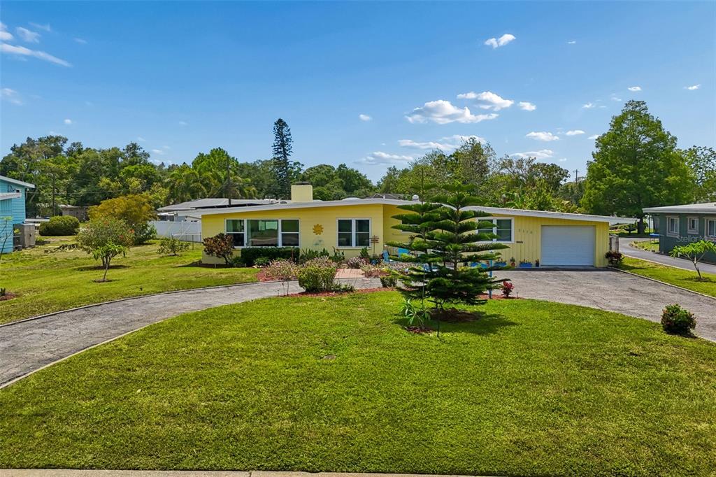 A yellow single-story house with a curved driveway and a large front lawn — 2110 FAIRWAY AVENUE S, ST PETERSBURG, FL