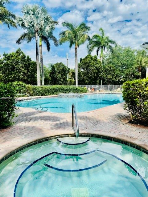 A view from a tiled balcony overlooking a grassy courtyard between two residential buildings — 556 NW 39th Cir, Boca Raton FL 33431, BOCA RATON, FL