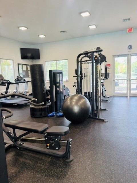 This gym features various exercise machines, a punching bag, and a large stability ball — 556 NW 39th Cir, Boca Raton FL 33431, BOCA RATON, FL