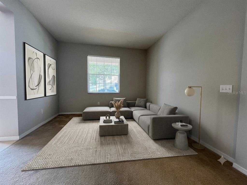 A living room features a gray sectional sofa, a square coffee table, and abstract wall art — 10411 KRISTEN PARK DRIVE, ORLANDO, FL