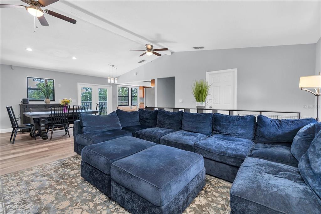 A large blue sectional sofa sits on a patterned rug in a living room — 15590 59TH STREET N, CLEARWATER, FL