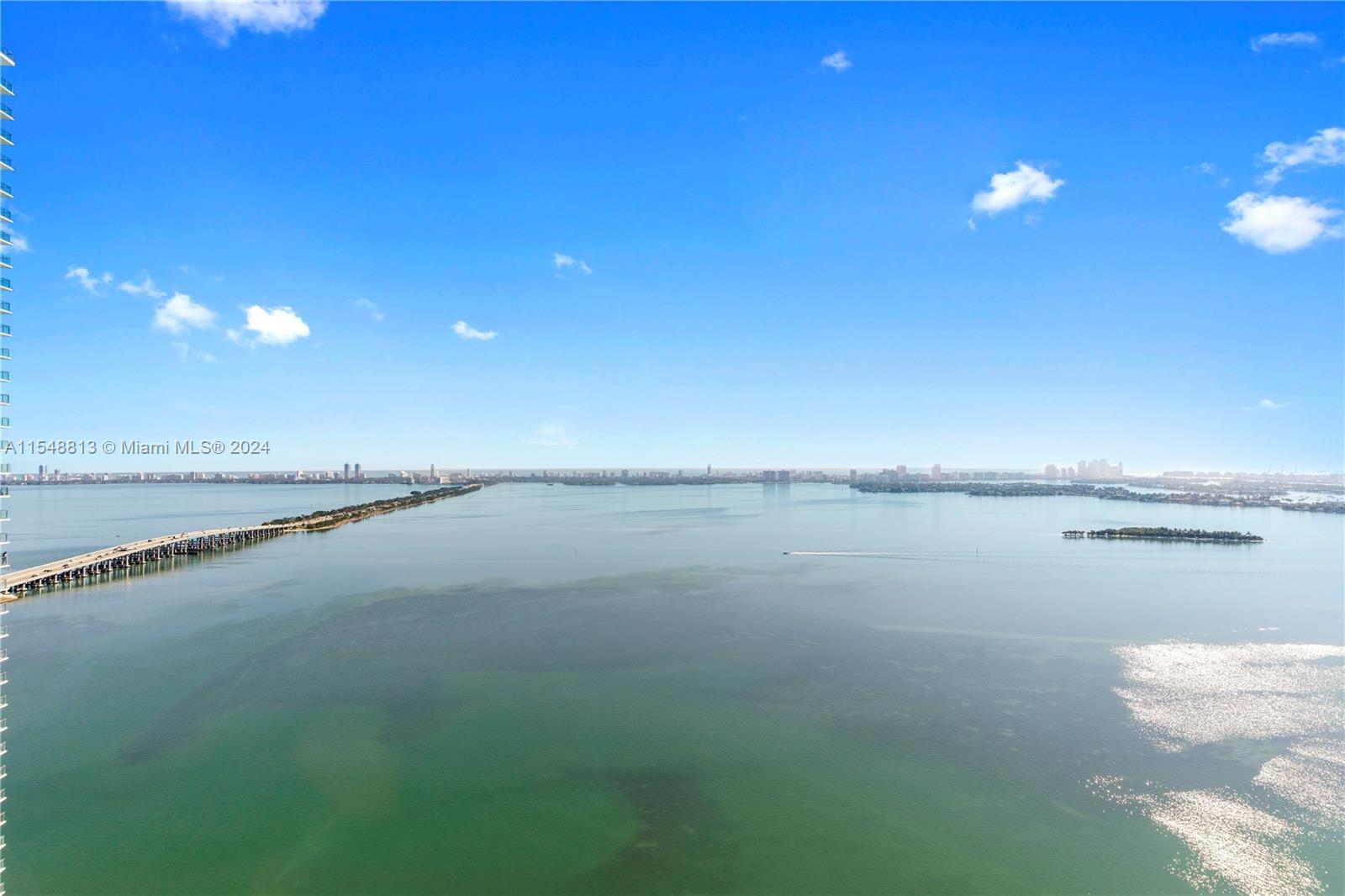 An aerial view shows a long bridge stretching across a large, calm bay — 480 NE 31st St # 2202, Miami FL 33137, MIAMI, FL