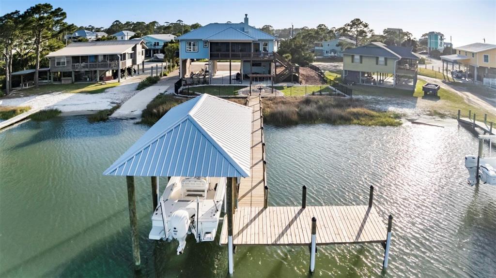 An elevated coastal house with a private boat dock and covered slip on the water — 331 LAND STREET, EASTPOINT, FL
